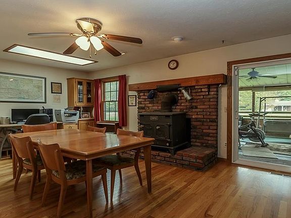 DINING ROOM OFFERS WOODBURNING FIREPLACE, WOOD STOVE AND HARDWOOD FLOORS