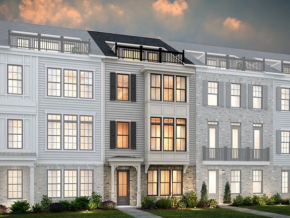 Bainbridge Exterior 27 features James Hardie TM siding, covered front door, brick, terrace and 2 ca