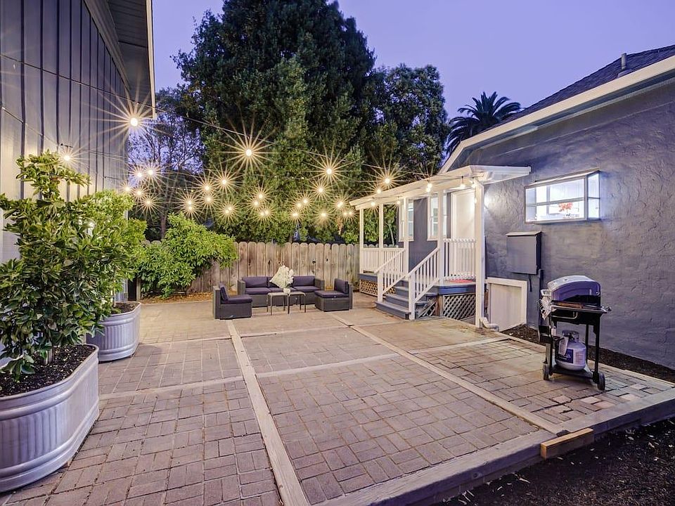 Backyard with string lights & BBQ grill