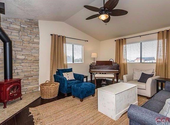 This quaint space is warm and welcoming with its wood burning fireplace, wood floors and vaulted cei