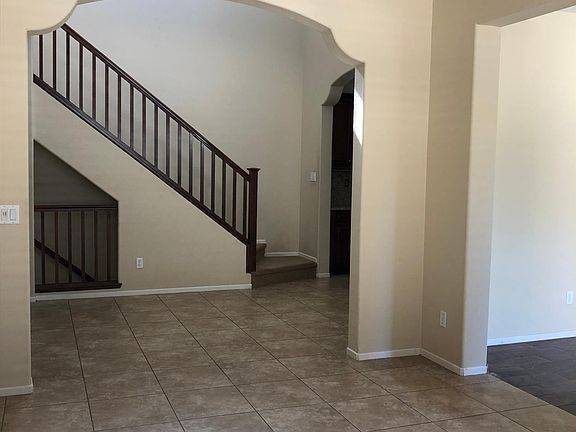 livingroom view to dining area near kitchen, and stairs to master bedroom