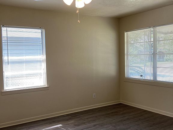 Welcome to the living room with fresh paint, new ceiling fan and flooring with lots of natural light.