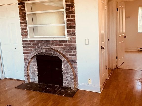 Fireplace in living room, and hallway to bedrooms and full bathroom