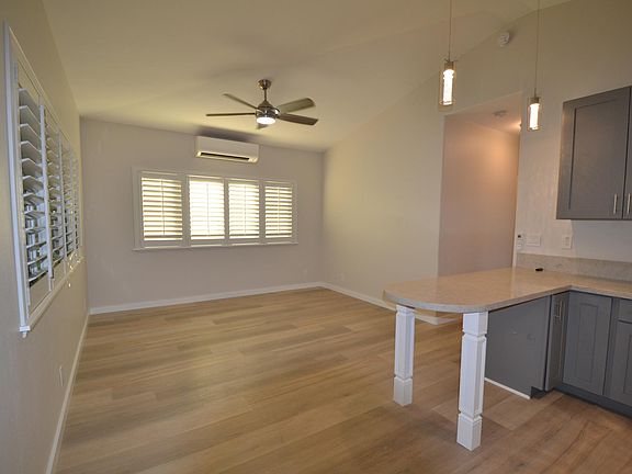 Spacious living room with split a/c and built in shutters for privacy.