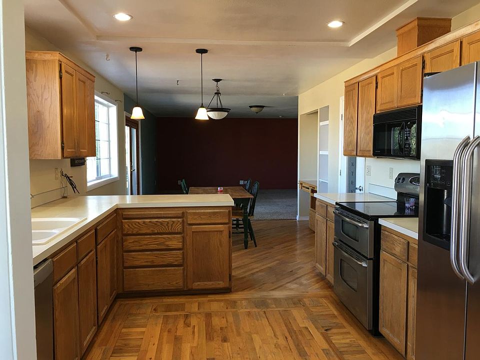 Kitchen open to dining and family room with a door to the de