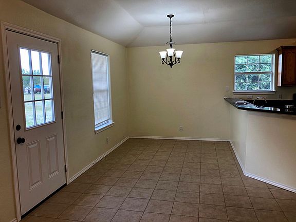Eating area with backdoor and kitchen breakfast bar