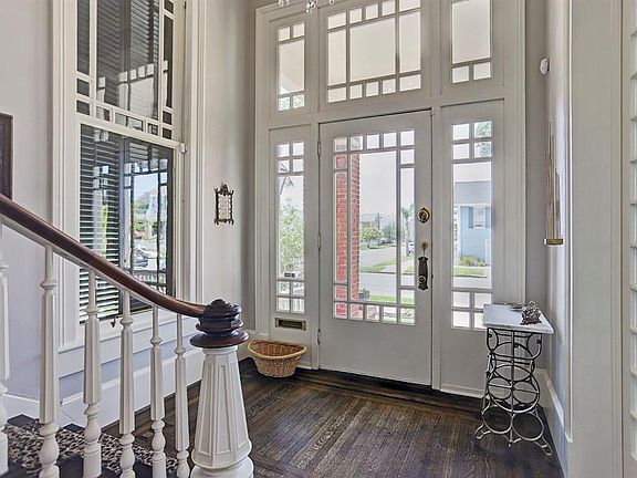 Inviting entryway with tiger-eye oak wood flooring,high ceilings and gorgeous architecture.