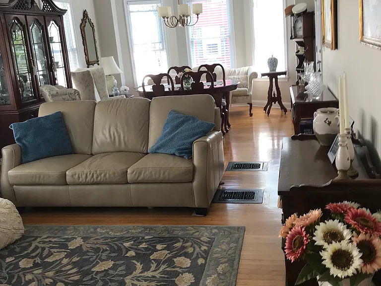 Large bright dining living room with hardwood floors.