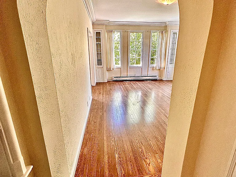 Unit #303-entry archway leading to spacious living room