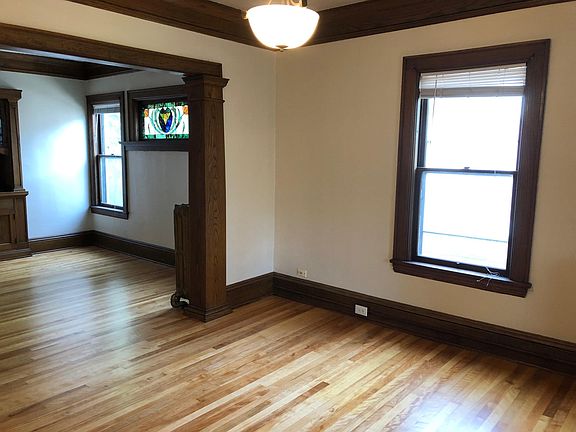 Living room & dining room with original stained glass window