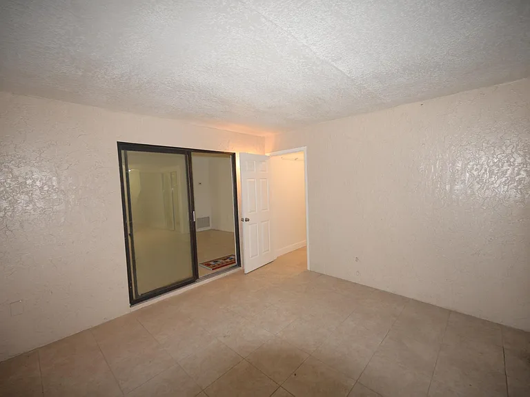 Walking into the screen porch ,laundry door and sliding glass door into the apart