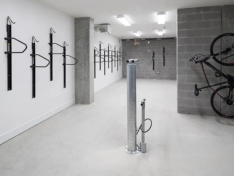 Bike storage room with storage racks and repair station.