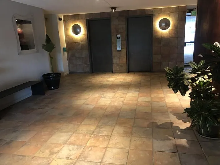 Inviting lobby with artwork, modern lighting and tile throughout.
