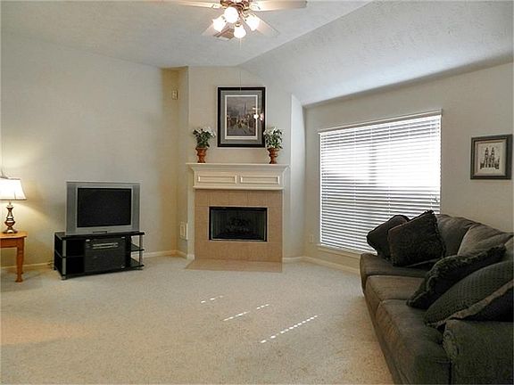Berber carpet and tiled mantle piece.