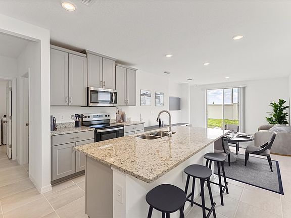 Staged kitchen in the Denali floorplan at 1945 Harrods Place in Bradbury Creek