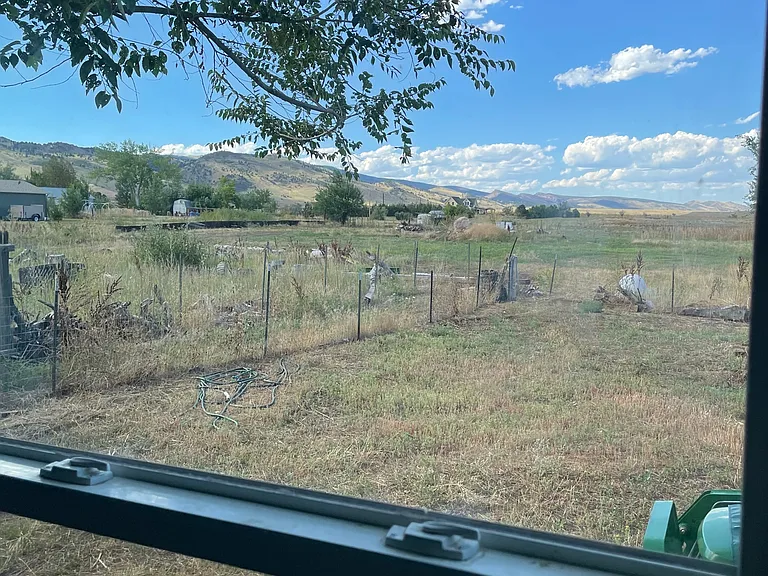 Views from the kitchen to the back yard and Front Range mountains.