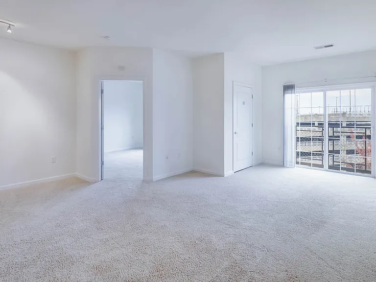 Carpeted Living Room with Balcony
