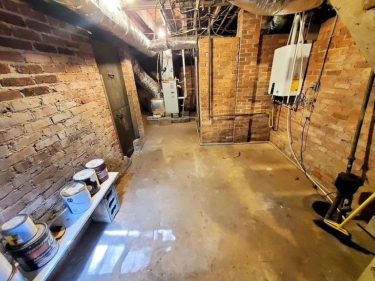 Basement with HVAC, tankless Navien, and Sump pump
