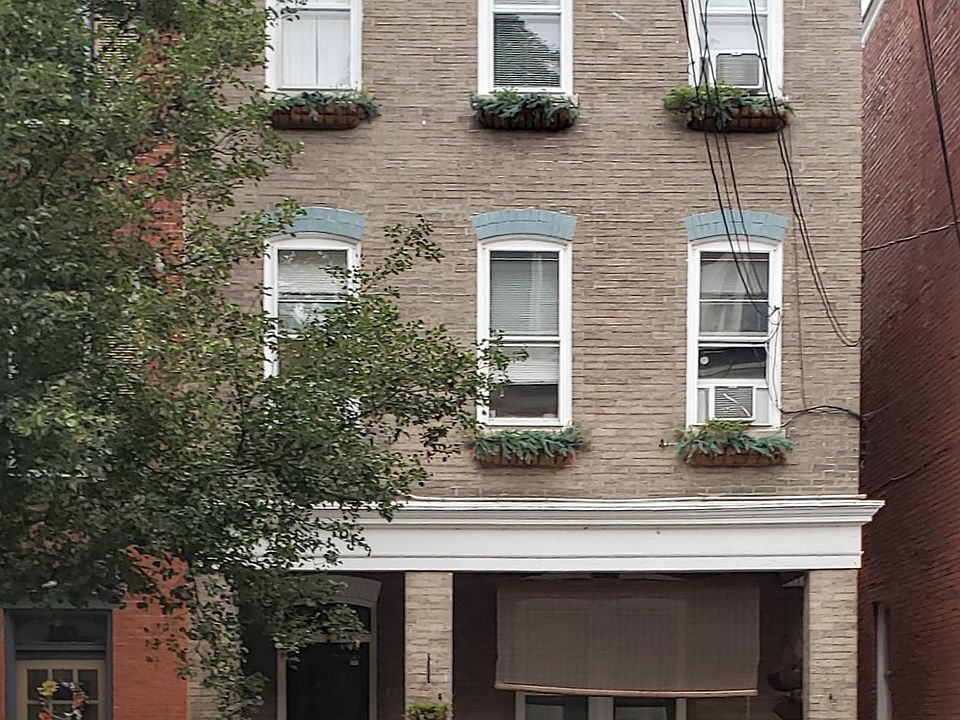 The apartment is on the second floor. The three windows above the porch look out from the kitchen and living room.