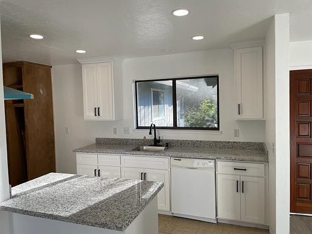 Kitchen with new solid wood cabinets and new granite. Brand new range and hood. Painting to be completed on large pantry.