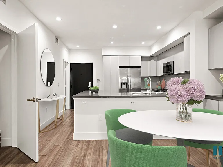 Open-Concept Kitchen and Dining Room with Hall Closet and Built-In Storage Cabinets