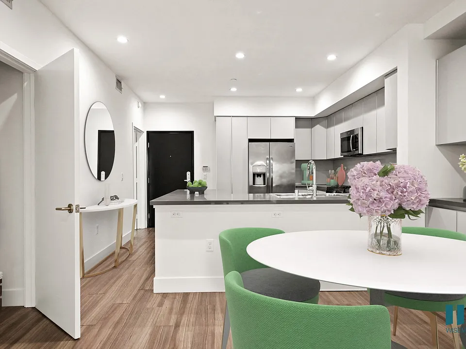 Open-Concept Kitchen and Dining Room with Hall Closet and Built-In Storage Cabinets