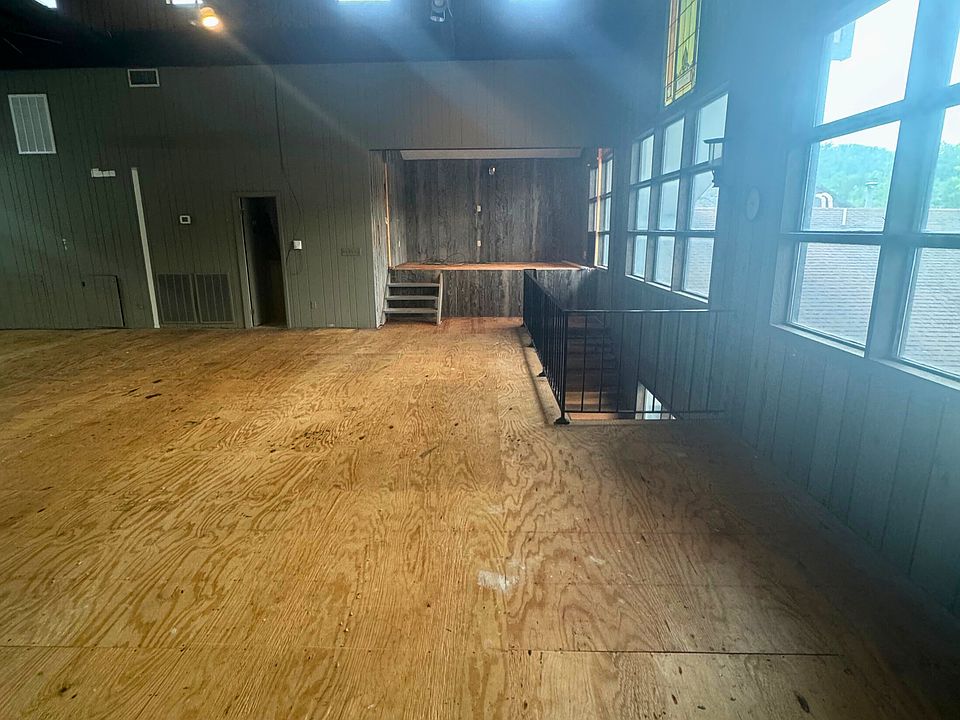 Interior view: large, open layout with high ceilings. Staircase leading down, gives access to 2nd entrance.