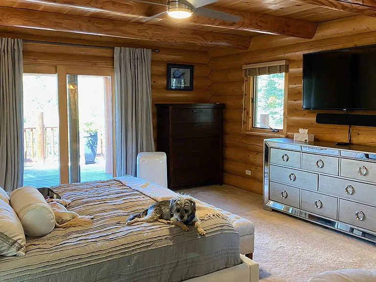 Master bedroom with back deck access to outdoor spa.