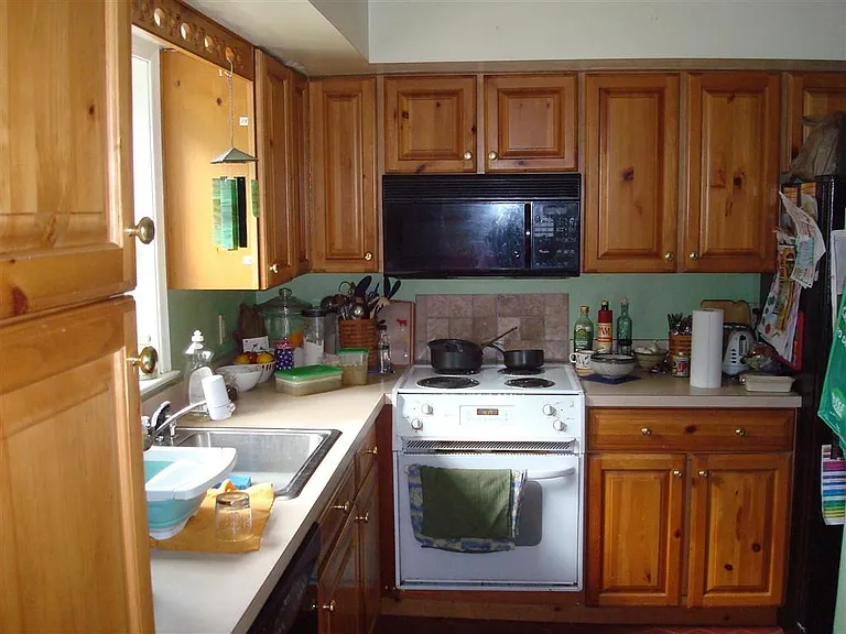 Kitchen with dishwasher, microwave, range, and refrigerator.