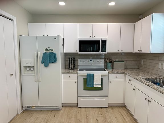 This newly renovated kitchen includes granite countertops, fridge, freezer, microwave, stove, oven, dishwasher, garbage disposal, and under-the-sink water filtration. It's fully stocked with dishes, pots and pans, silverware, crockpot, blender & more