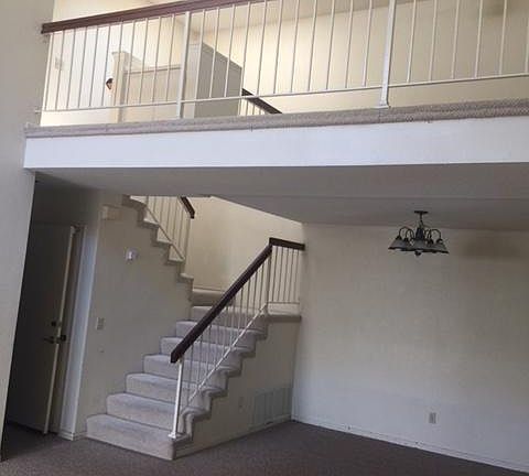 Stairs heading to upstairs bedrooms and upstairs loft with s