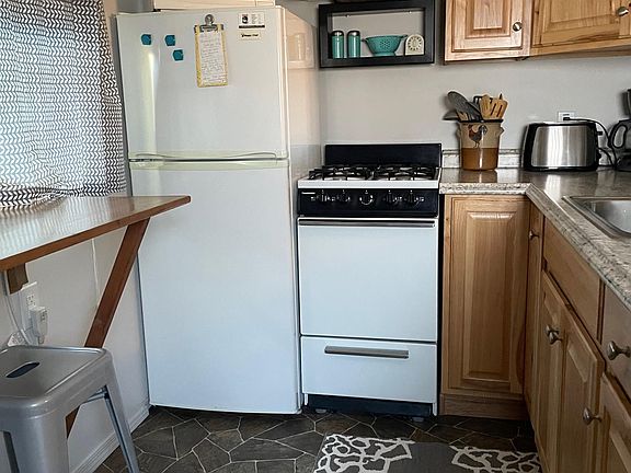 Kitchen showing pine counter with 2 bar stools
