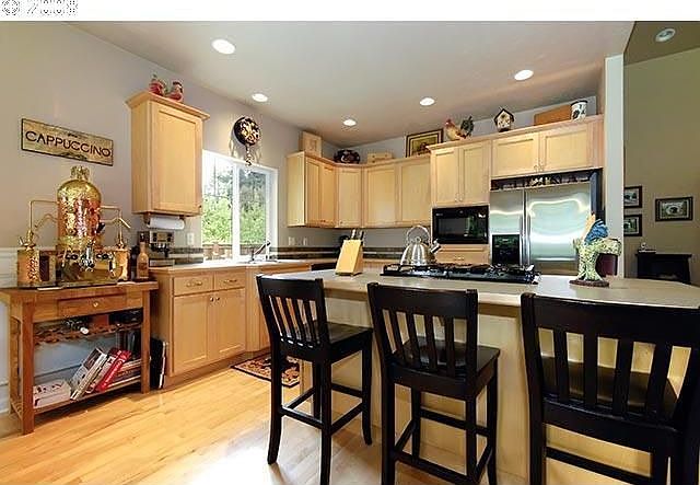 Maple Cabinets and Floors in Kitchen with Breakfast Bar