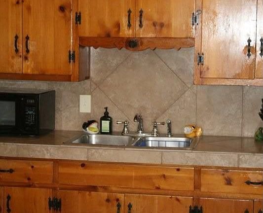 Updated tile, backsplash, plumbing fixtures in kitchen