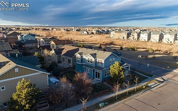 Rear side aerial view of home on corner lot
