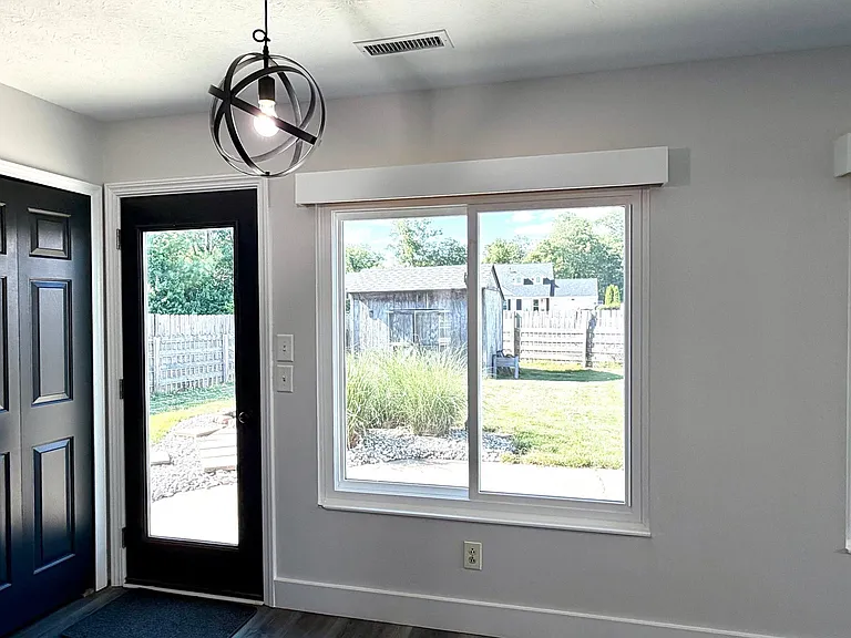Dining area off kitchen, access to the expansive, rear concrete patio and large fenced rear yard