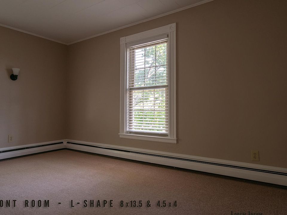 Entering the apartment brings you into the front room - it can be used as a common space or den. The stairs to go to the third floor is just to the left, out of frame.