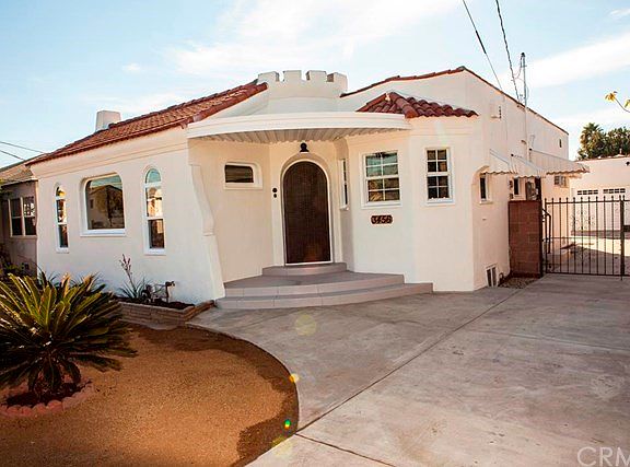 Steps up to wood door with stained glass detail.