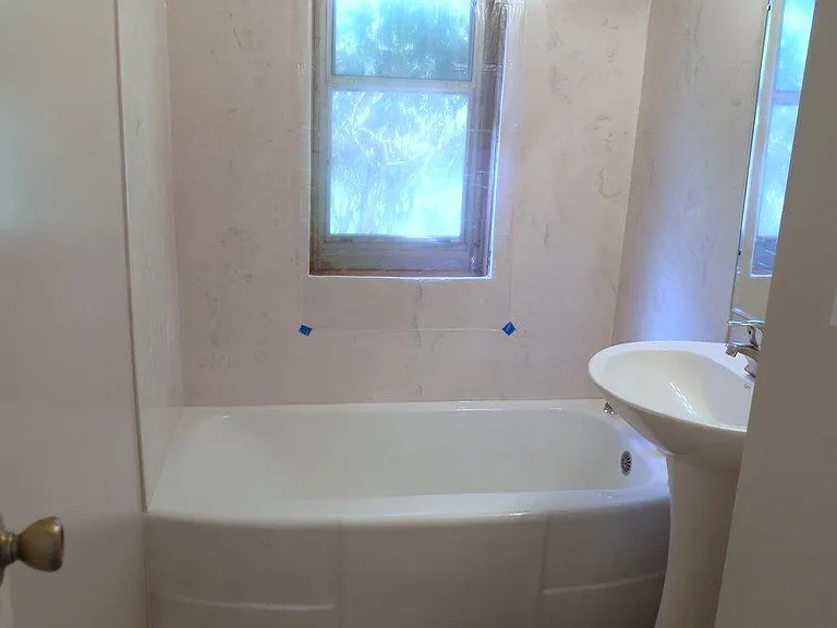 Cultured marble shower siding. Note that a translucent block window has now been installed.