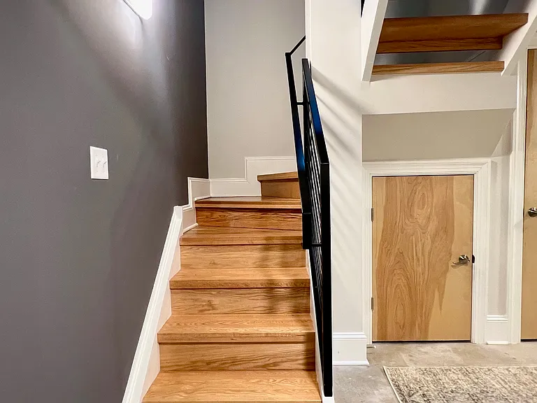 Staircase leading up to living/dining/kitchen level.