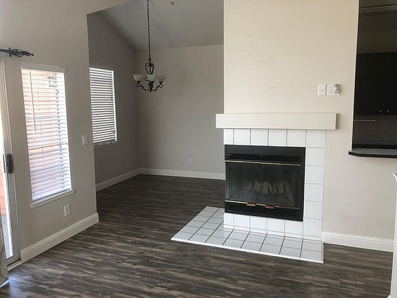 View of dining room/fireplace from living room. Outlooks for TV hook up above fireplace