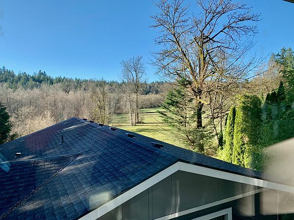 View from the bedroom window frames neighboring horse farm, beautiful greenery, and open fields