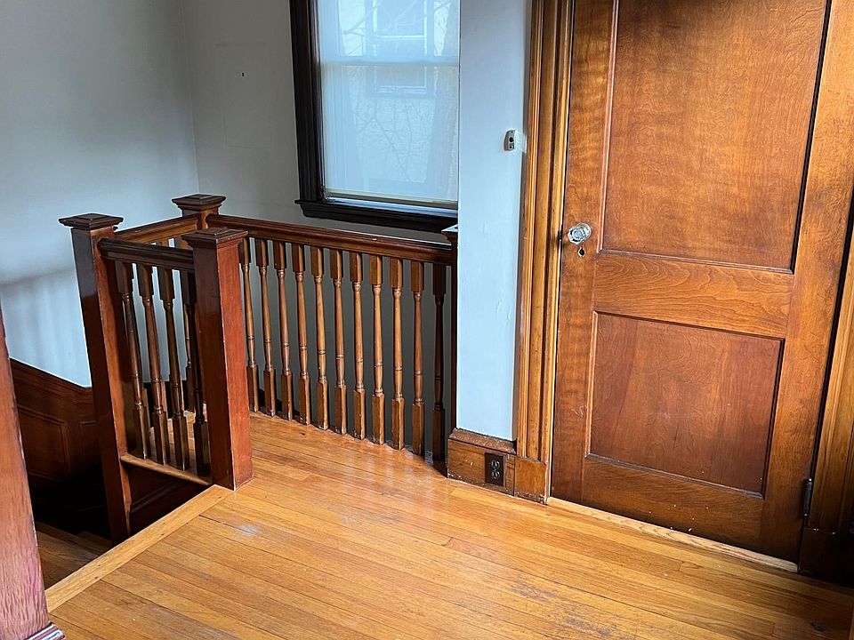 Front stairway entrance into living room with large coat closet.