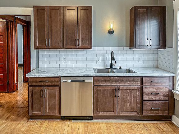 Renovated kitchen with new cabinets, countertop, beautiful backsplash & stainless steel appliances