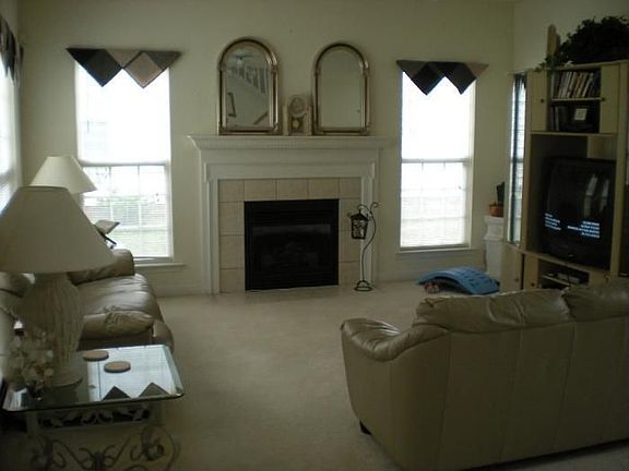Den open to breakfast area and wet bar