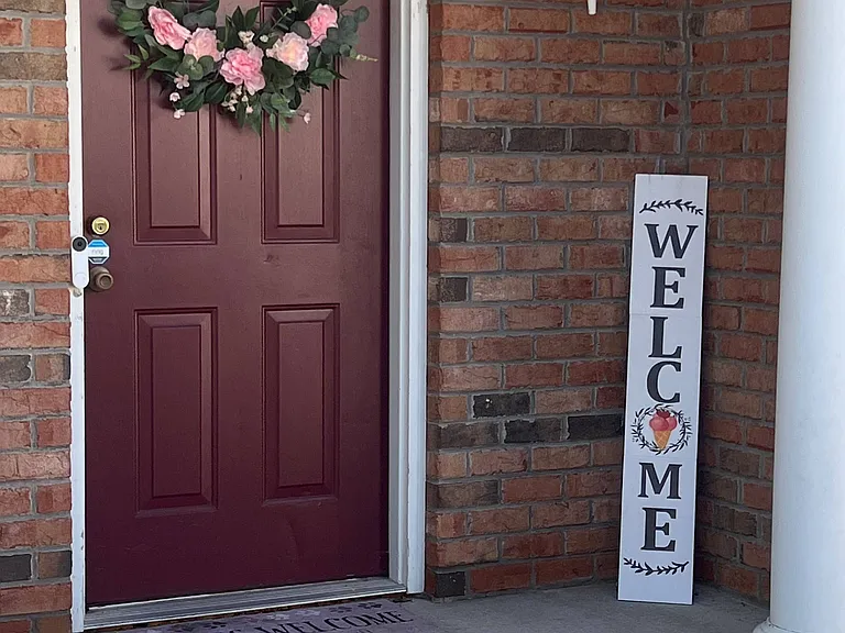 View of covered front porch entrance door