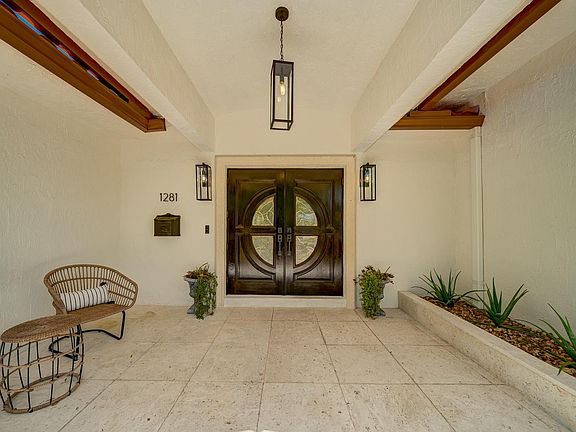 Front patio with decorated aloe vera plants on side. Easy getting furniture through the double doors.