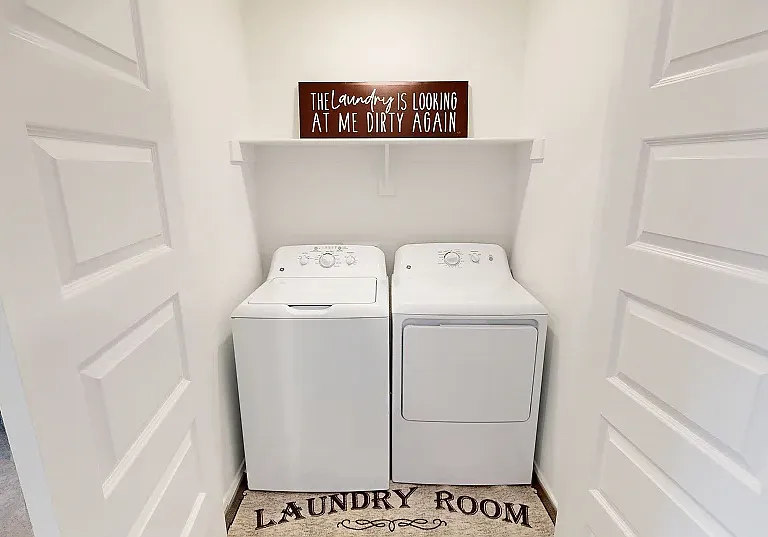 Laundry Room
Enjoy simple chore days with an overhead shelf and space for a new washer and dryer in the laundry room, with convenient French doors to keep mess out of sight.