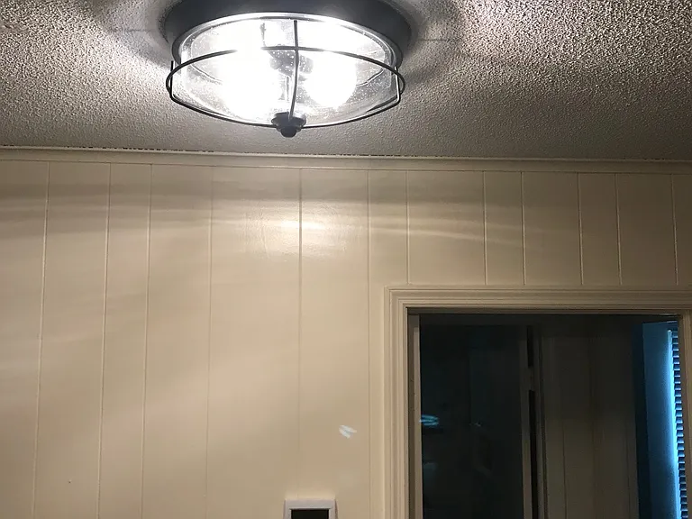 standing in kitchen looking at dining nook towards the bathroom ( ahead) and bedroom ( right)