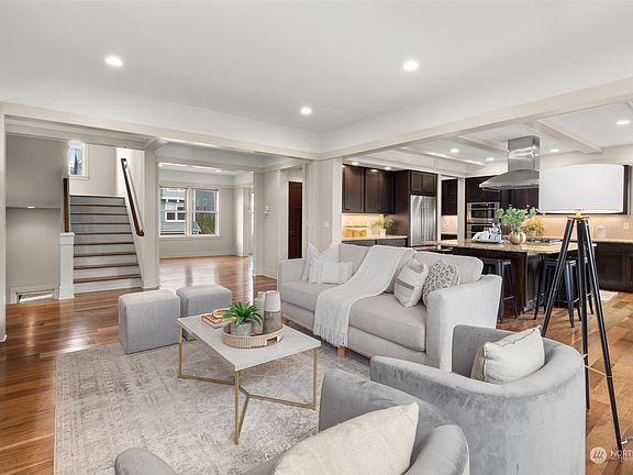 The kitchen and main living areas are located on the middle floor of this three-story house.  >
